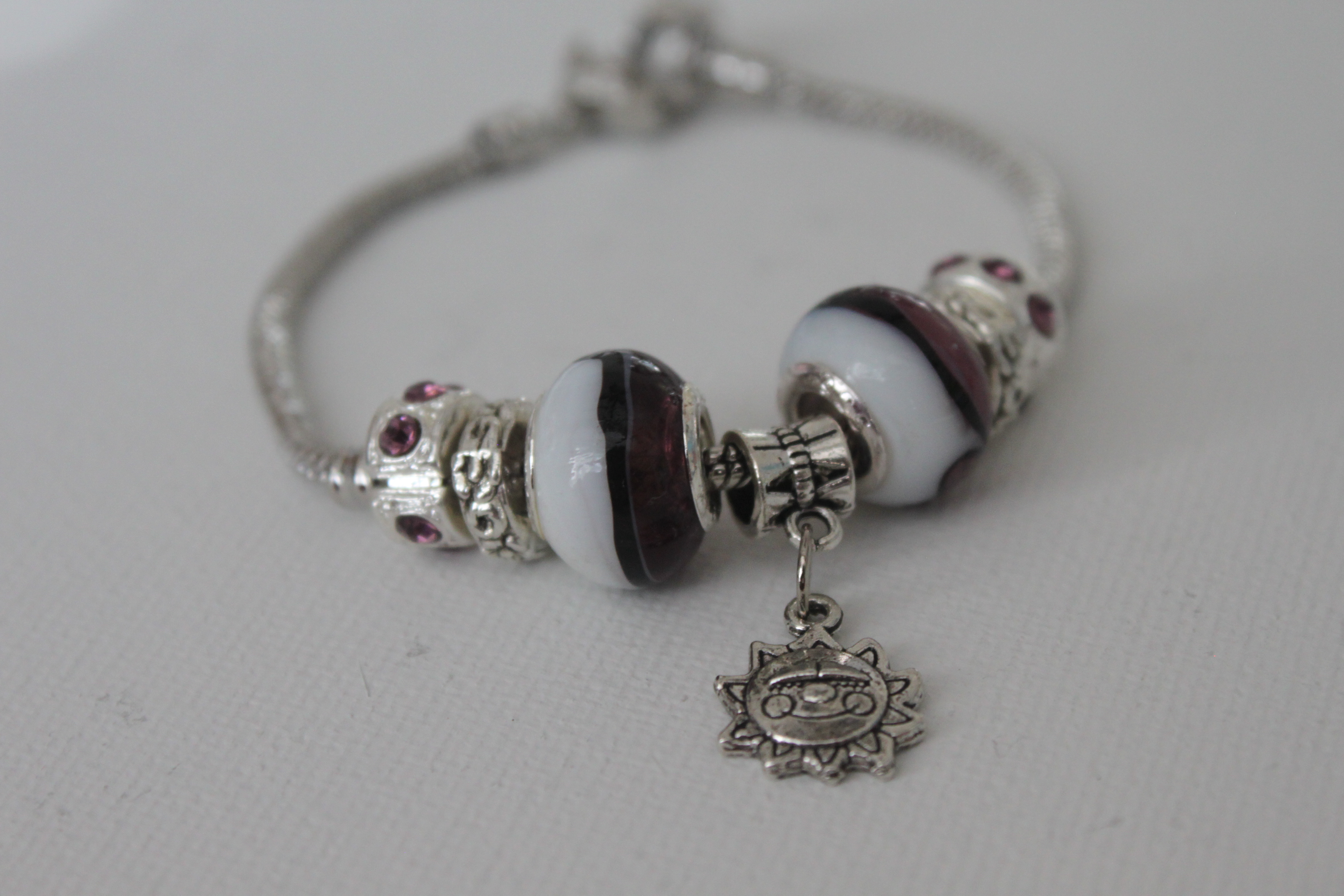 Sun charm bracelet white black