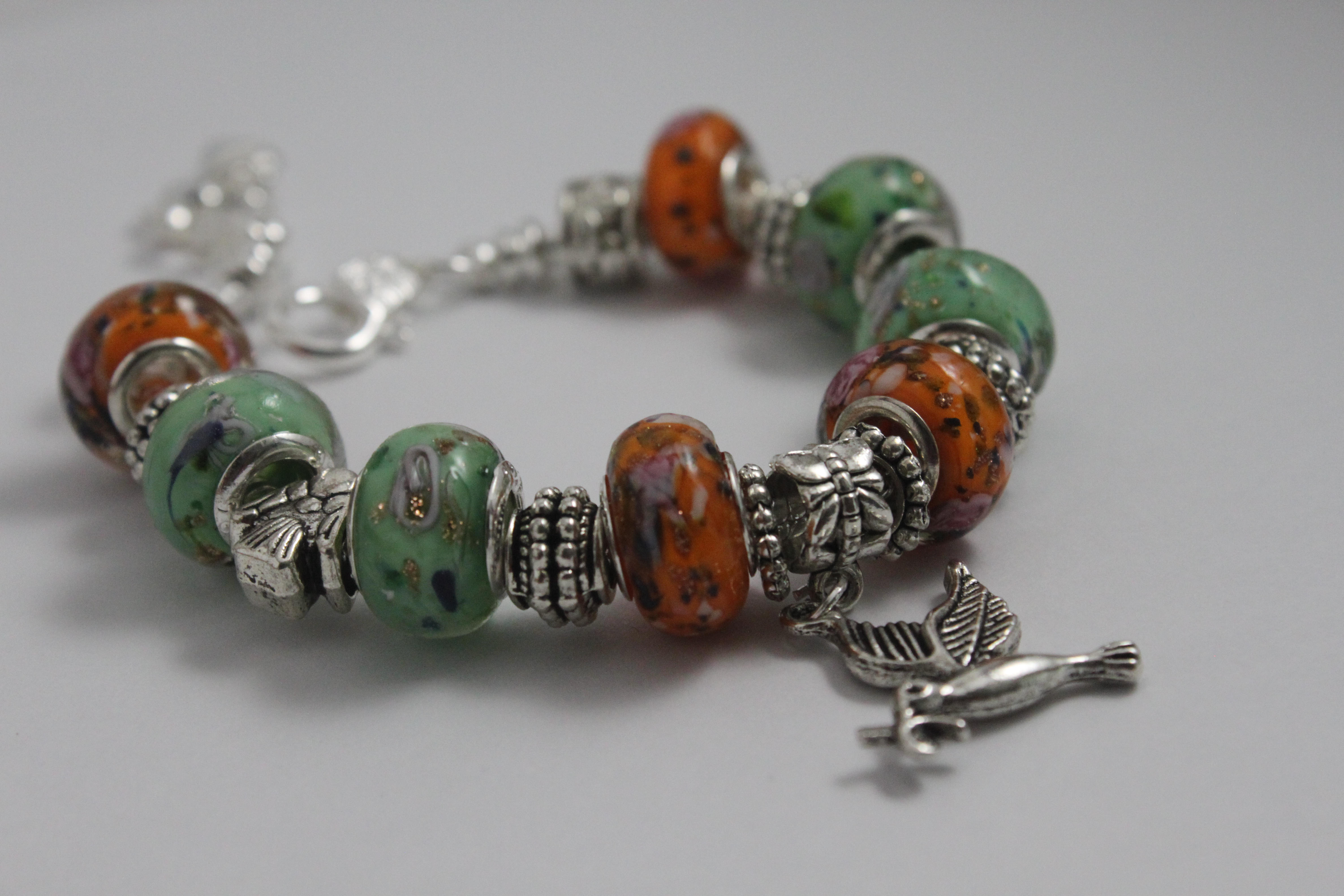 Bird charm bracelet - orange green
