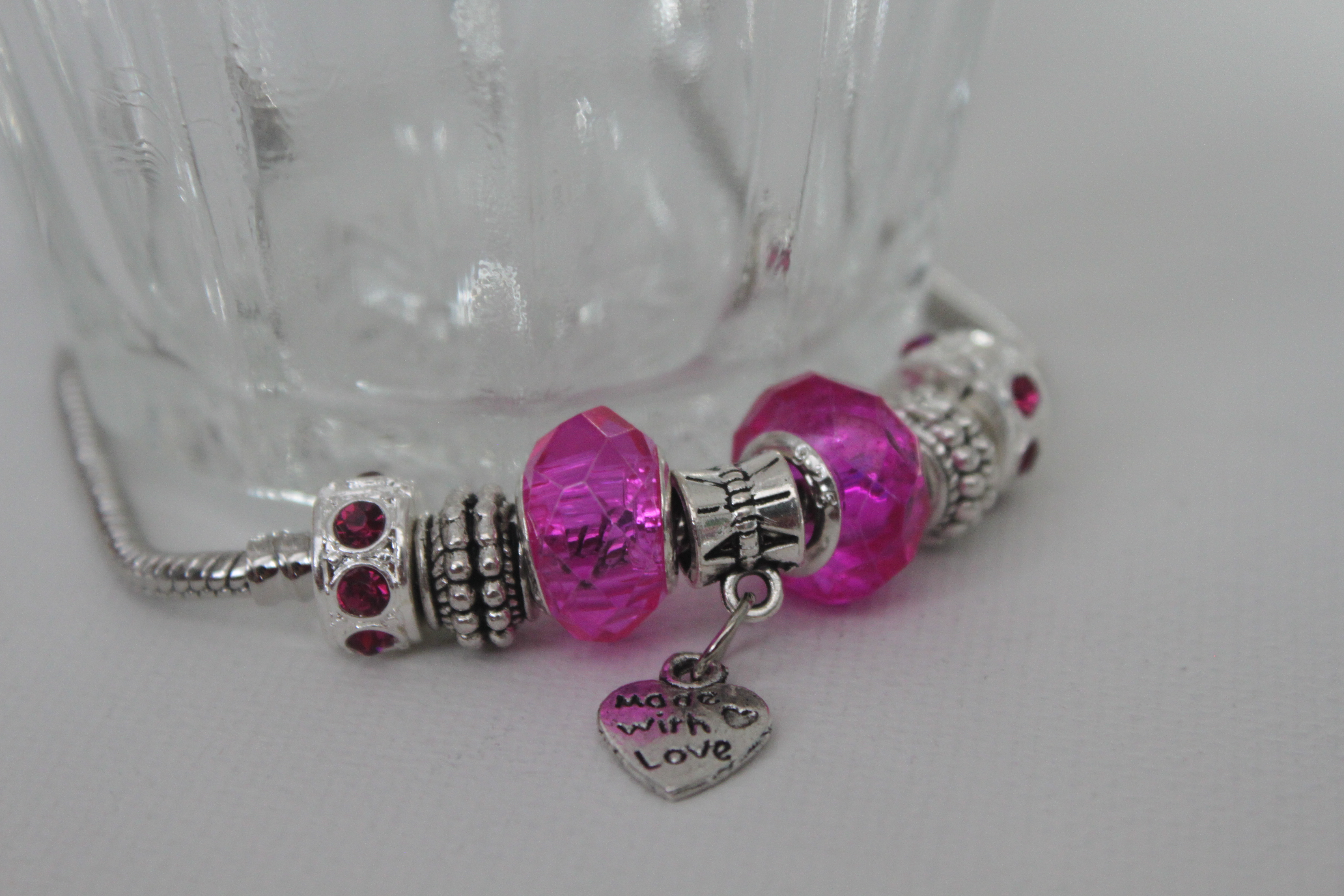 Love charm bracelet in rose tone