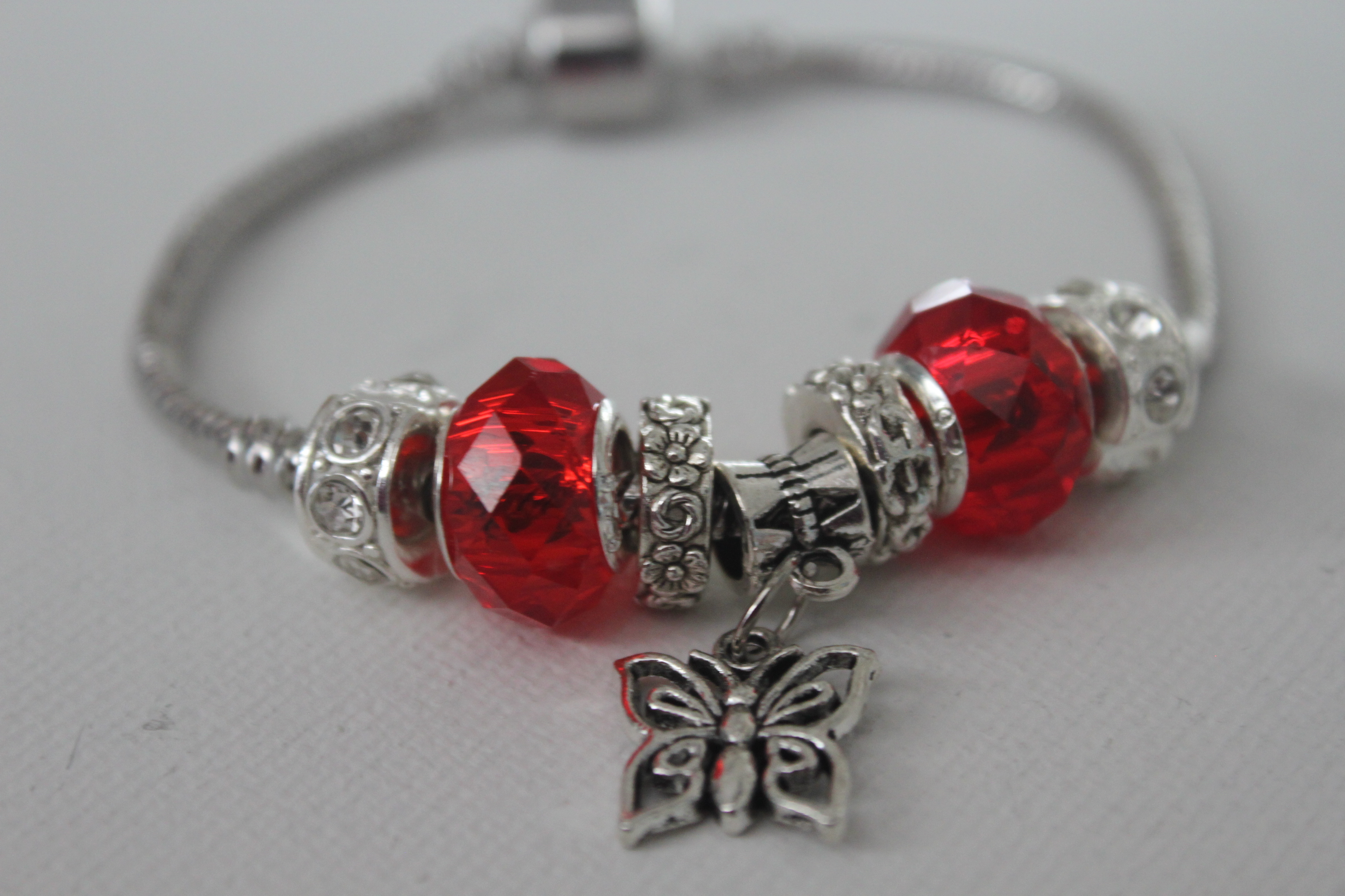 Butterfly charm bracelet in red