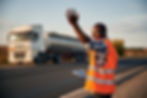 showing-way-black-man-is-standing-road-with-truck-it (1).jpg