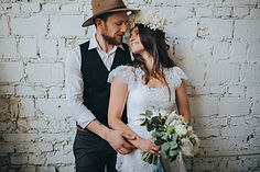 A groom embracing his bride during their wedding in Denmark.