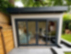 Compact garden office in Nottingham with Pearl Grey Hardie® Plank cladding, anthracite sliding doors and side window.