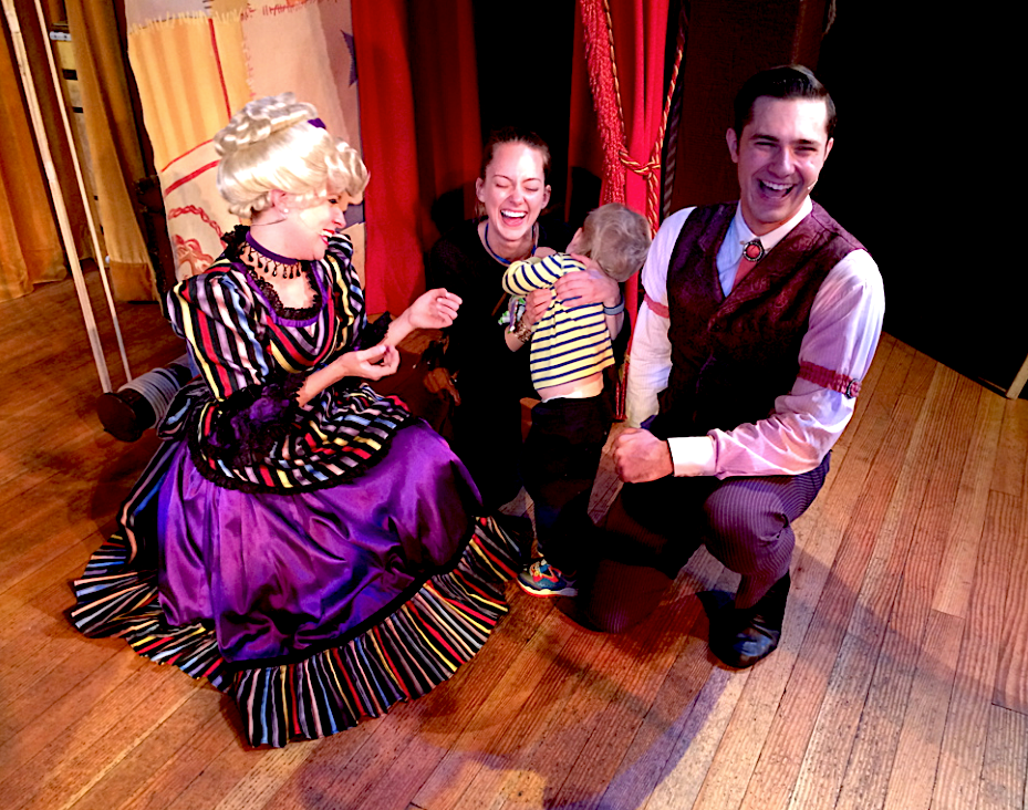 Characters at the Hoop Dee Doo Musical Revue at Disney world posing with a laughing mother and son