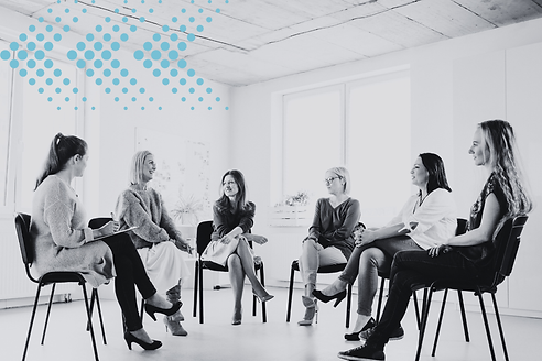 team of staff sitting in a half circle engaged in a facilitated discussion