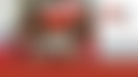 Red cocktails with sugar rims and star garnishes in front of a decorated Christmas tree. WorkplacePLUS logo and website on the right.