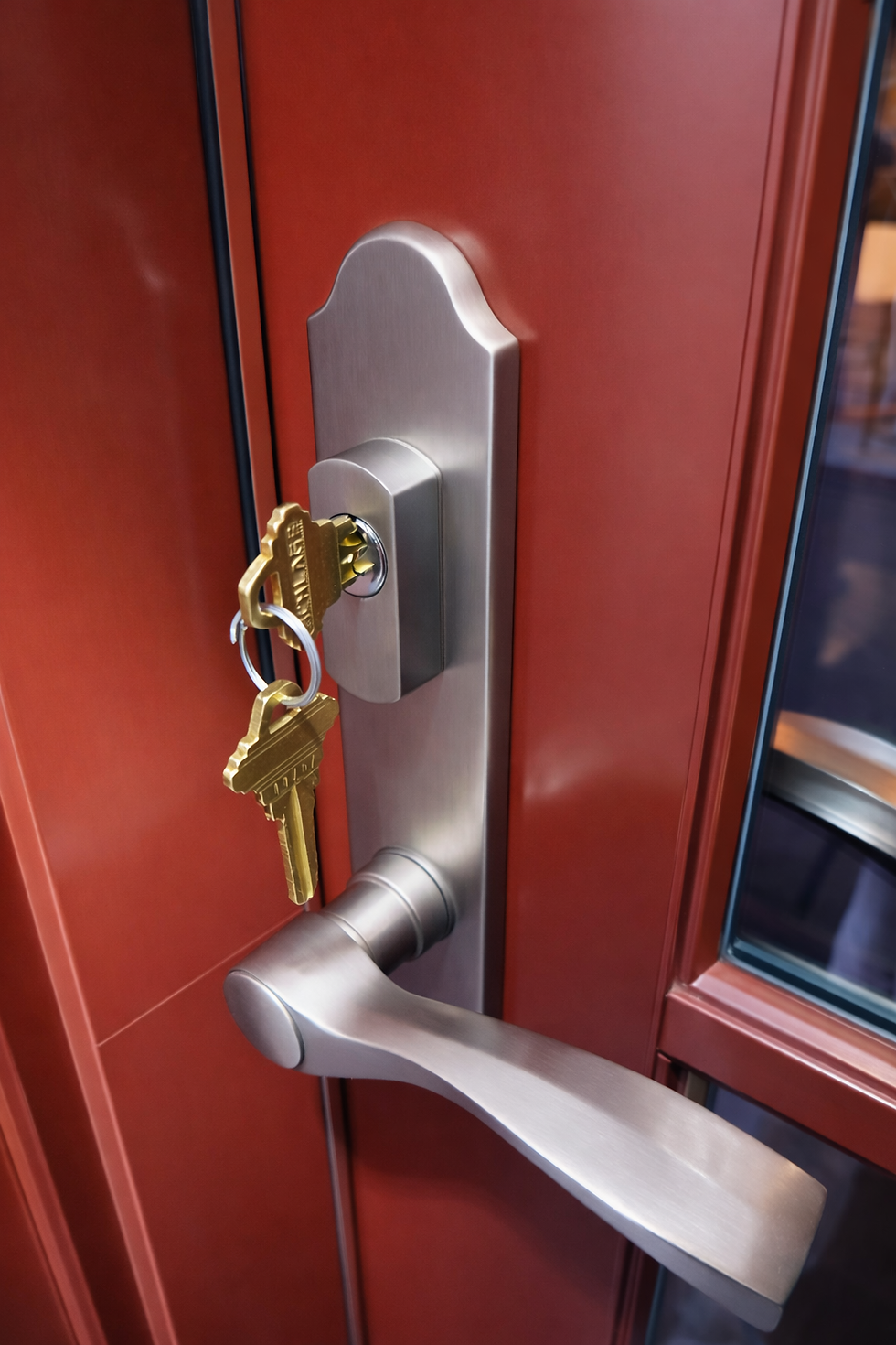 Eye-level view of a locksmith installing a deadbolt lock on a residential door