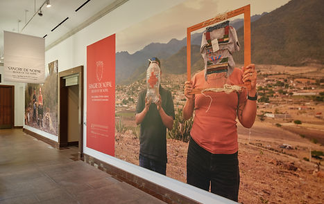 display wall in hallway with a large image of two figures holding objects in front of their faces