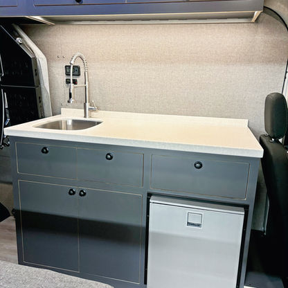 52-inch kitchen galley cabinet in Ford Transit camper van with integrated storage and mechanical systems.