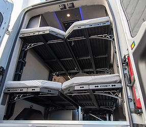 Rear view of 2025 Transit camper van with Code 7 queen bunk beds and mattresses, showcasing adjustable sleeping configurations for DIY and professional builders.