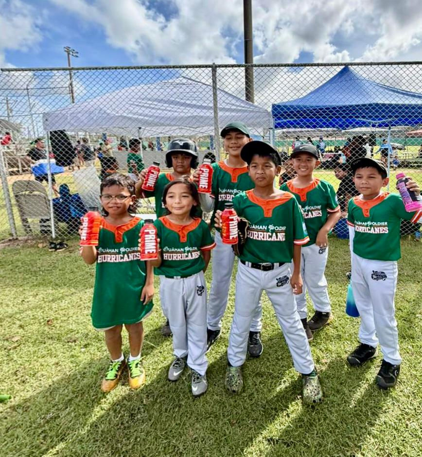 Young players from the Guåhan Soldier Hurricanes youth baseball team holding bottles of Prime, donated by PDC Wholesale, during a local game day event.