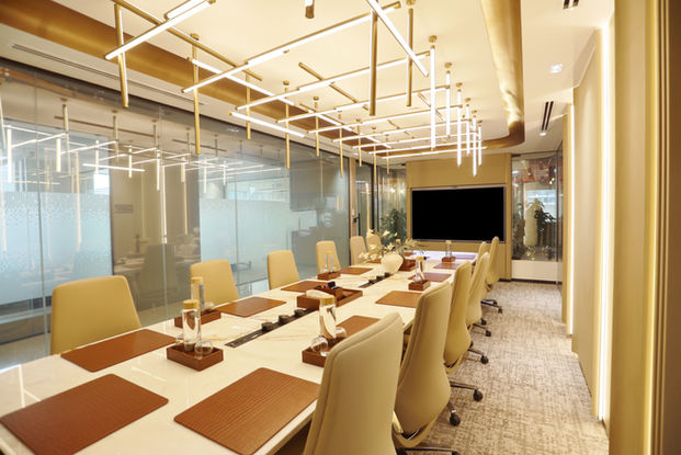 Modern conference room in serviced offices with long table.