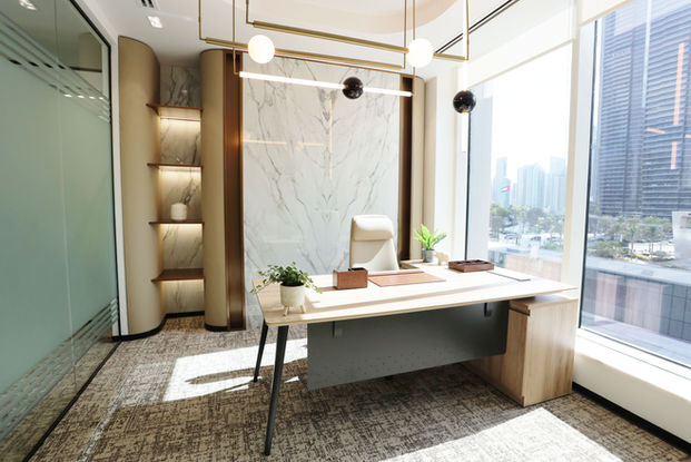 Modern private office with a marble wall and city views.