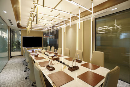 Modern conference room with long table and leather mats.