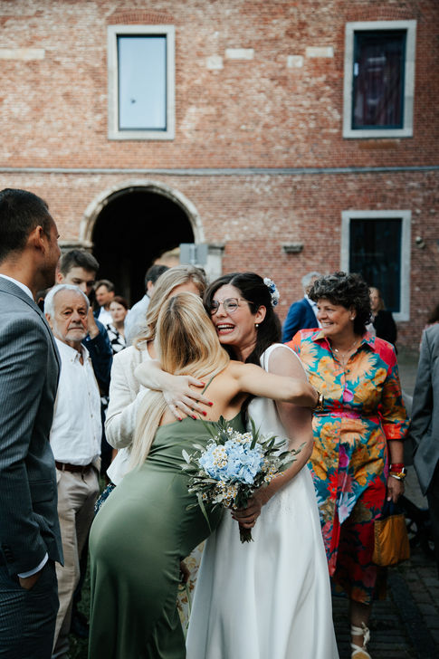Braut umarmt Freundin zur Begrüßung - Emotionale Hochzeitsfotografie Köln