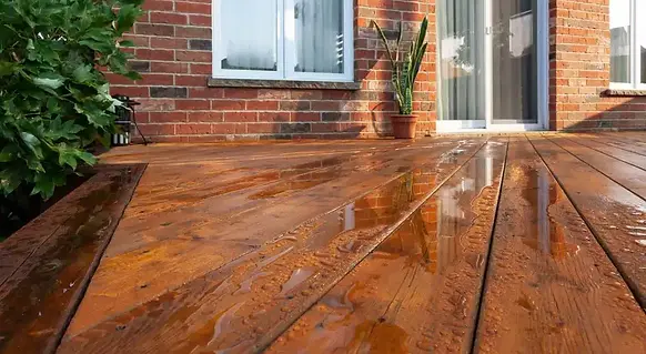 Freshly cleaned and restored wooden deck after professional pressure washing and sealing service.