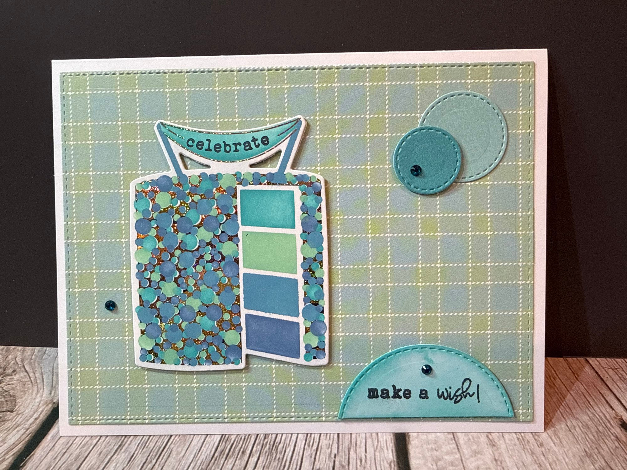 Greeting card: green plaid, "celebrate" cake, and "make a wish!".