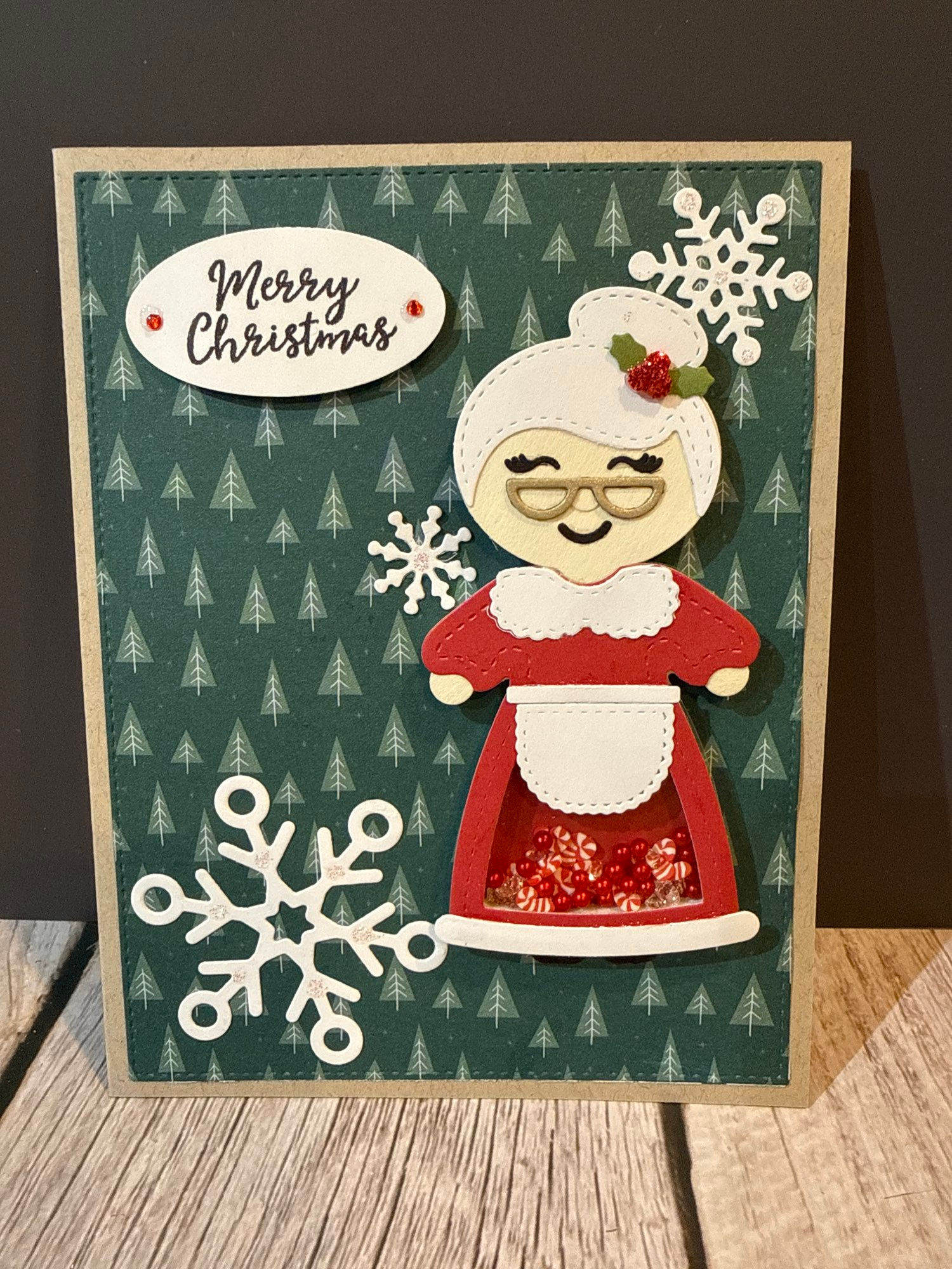 Handmade Christmas card featuring Mrs. Claus, "Merry Christmas", snowflakes, green background.
