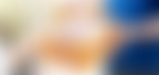 Hands exchange a brown box with purple floral designs and "doTERRA" text. Background shows sunlight on a blurred fence.