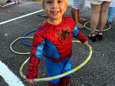 A little boy in a spiderman suit