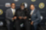 Luis Clemente and Roberto Clemente Jr. posing with guests at the Roberto Clemente Foundation Ambassador's Reception 2026 Pittsburgh, PA venue photo