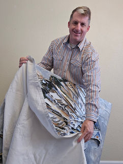 man wrapping art with blanket
