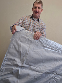 good looking man wrapping art, smiling like a boss