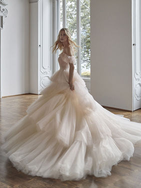 SALE DRESS
This is the dress to truly make a statement, think pure princess
This Incredibly romantic ballgown has layers upon layers of beautiful soft ruffled tulle.
She has an incredible statement V-neck, low scoop back and delicate off-shoulder ruffled sleeves.
Was 2790 - Now £995
Dress is in perfect condition, the lining is slightly marked from use on a shoot