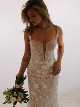 A form fitting wedding dress showcasing a floral romantic detailing