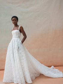 Intricately textured cut out floral organza fabric is cut into clean lines with a dramatic silhouette for the strikingly romantic Charlie gown. Slightly tapered straps and a straight neckline create a sharp square neckline supported by a sculpted corset. The circle cut ball skirt is left semi sheer for a lighter than air feel.

Made to order - £2550
Love Me Now Sale Price- £1495