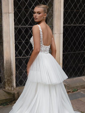 SALE DRESS - Introducing MILLIE, the ultimate wedding dress for the modern-day goddess. This breathtaking gown is a fusion of art and elegance, adorned with an enchanting combination of embroidery, 3D, and sequin sheet lace. The glitter mesh* and jersey lining add a touch of celestial allure, like stardust twinkling in the night sky. The square neckline illusion bodice, with its sheer side inset, exudes sensuality and confidence, reminiscent of a sultry music diva on stage. Centre back buttons offer a timeless charm, while the fit and flare skirt ensures a captivating silhouette as you walk down the aisle like a mesmerizing vision. With a detachable tulle and lace belt, MILLIE gives you the freedom to embrace your individuality and set your own trend. Step into the spotlight and claim your spotlight moment with MILLIE – the gown that makes your wedding dreams come true.
* sample in store does not have the glitter mesh
Skirt Sold Separately £655
WAS £1983 now £995