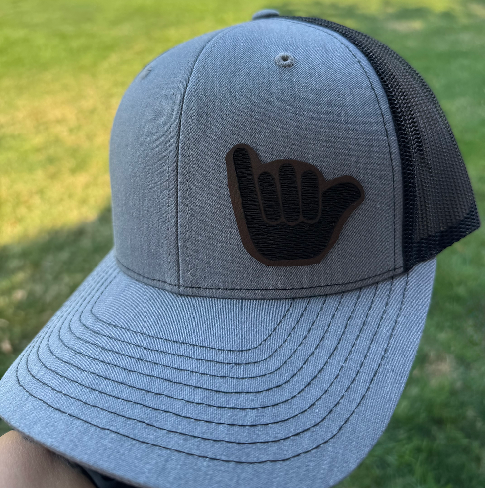 Grey and black mesh cap showing the Shaka symbol