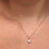Thumbnail: Woman wearing a delicate gold necklace with a single pearl pendant.