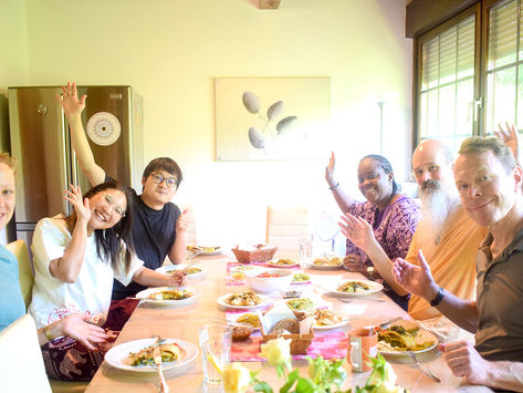 Happy people gathering around a dining table before they eat lunch