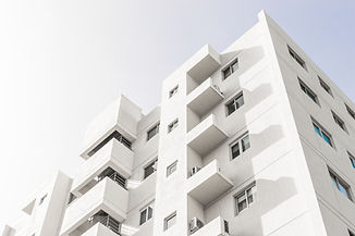 low-angle-shot-facade-white-modern-building-blue-clear-sky.jpg