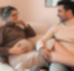Expecting couple relaxing together on a sofa