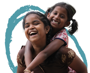 Two smiling girls, one carrying the other on her back, laughing joyfully against a blue background.