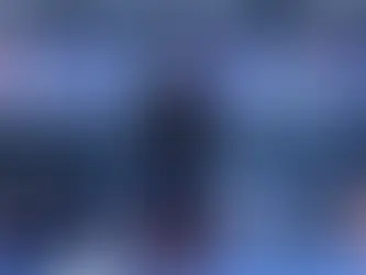 A women traveller at the airport taking a look at the arrival and departure billboard