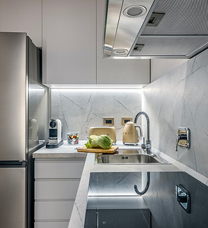 Kitchen facing the private courtyard, with induction cooktop, electric oven and in-unit washer–dryer, Monti, Rome