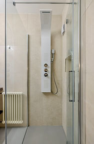Vanity with full-size mirror, ceramic sink and Dyson hair dryer in a private bathroom in Monti, Rome