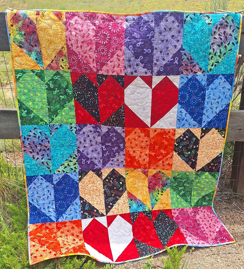 Thumbnail: With Joy, a Quilting Renditions fat quarter panel of heart shaped blocks, made with Island Batik Courageous Joy fabric