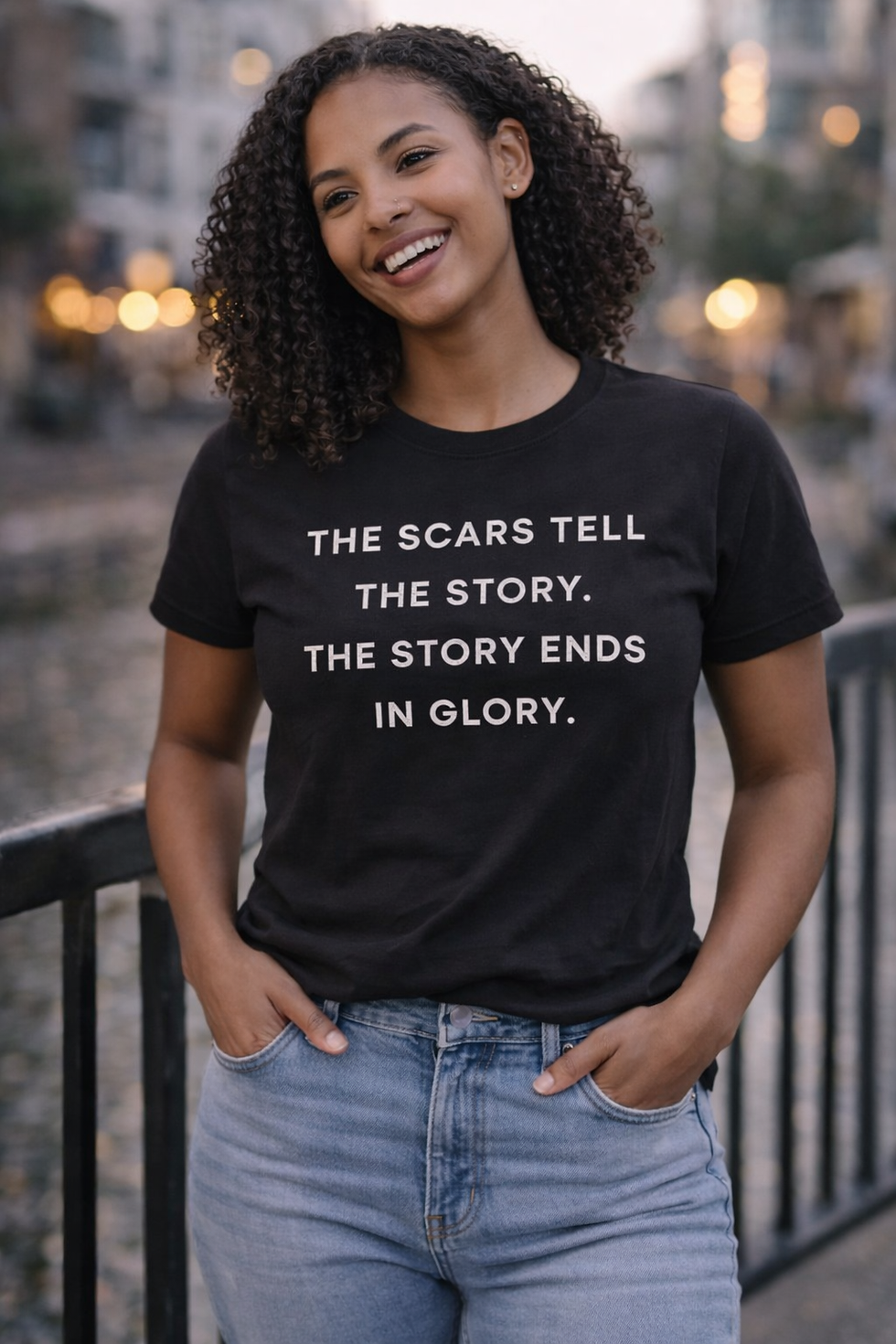 Thumbnail: Woman wearing black Christian T-shirt with “The Scars Tell the Story, The Story Ends in Glory” message