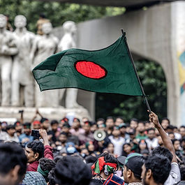 A student in Dhaka, Bangladesh, waves the national flag during a protest to demand a trial against the ousted leader Sheikh Hasina. (Luis Tato / AFP via Getty Images)