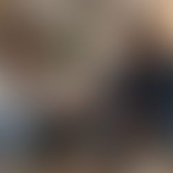 Couple in a tense conversation on a couch, illustrating why couples keep having the same fight and recurring relationship conflict