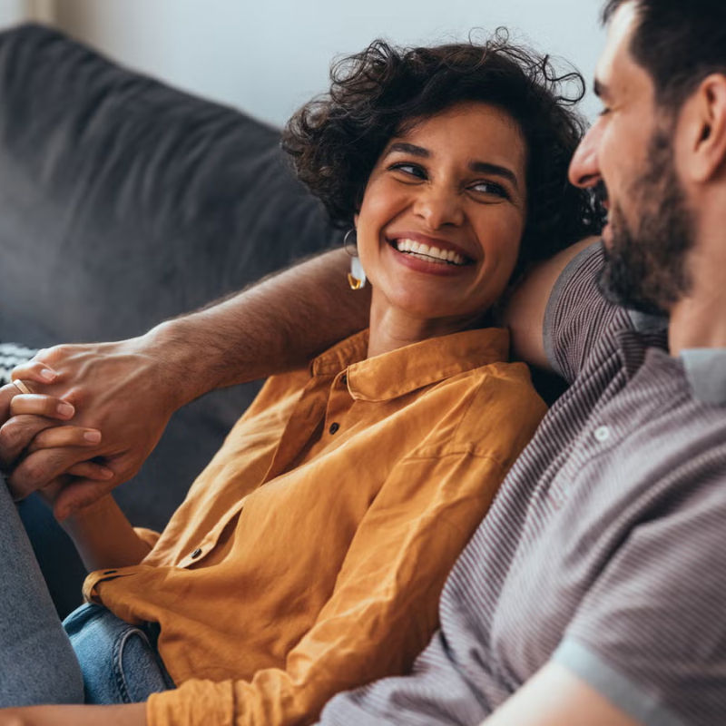 Couple navigating emotional reactivity and reconnecting during a vulnerable conversation at home