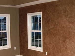 two interior walls meetinf at a corner. walls have a detailed faux finish to highlight the fine detail