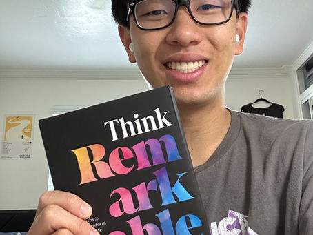 Eli Chan holding the book Think Remarkable
