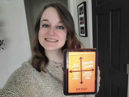 Brenna Holland holding the book Balance in Today’s Workplace Leadership by Kim Scott