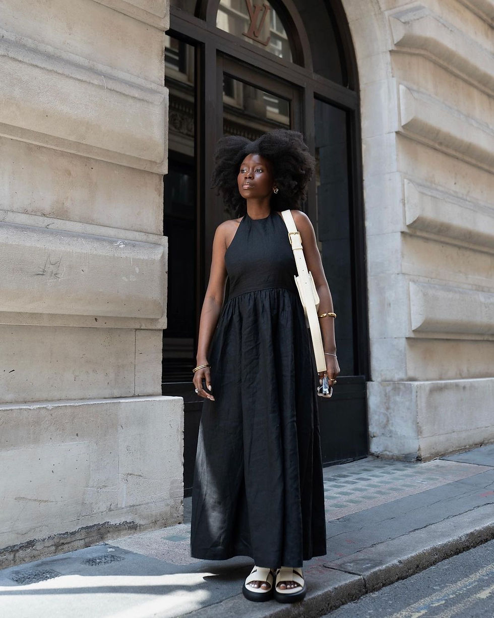 Flowy neutral maxi dress styled for luxury travel
