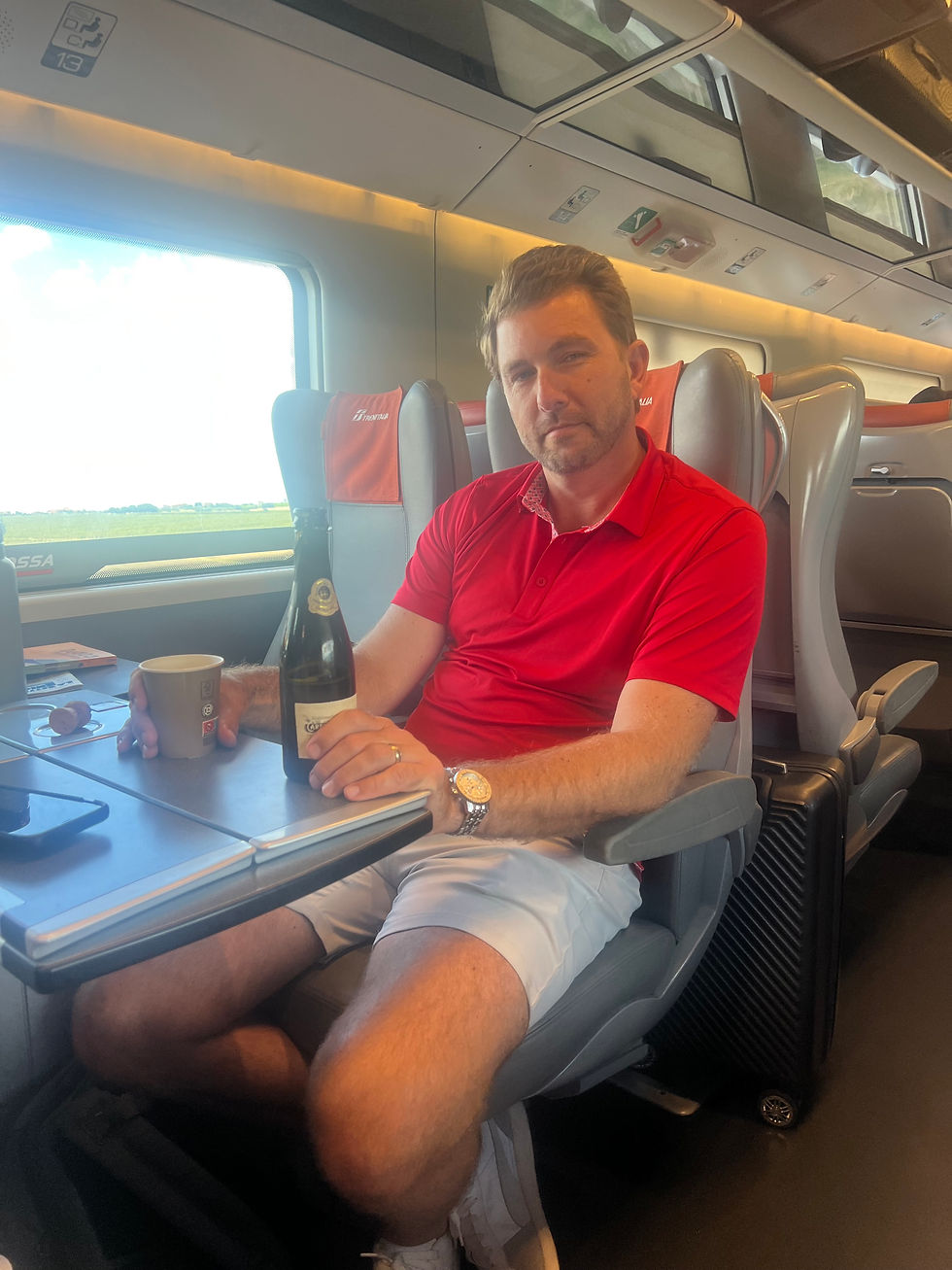 adult with wine on train in italy
